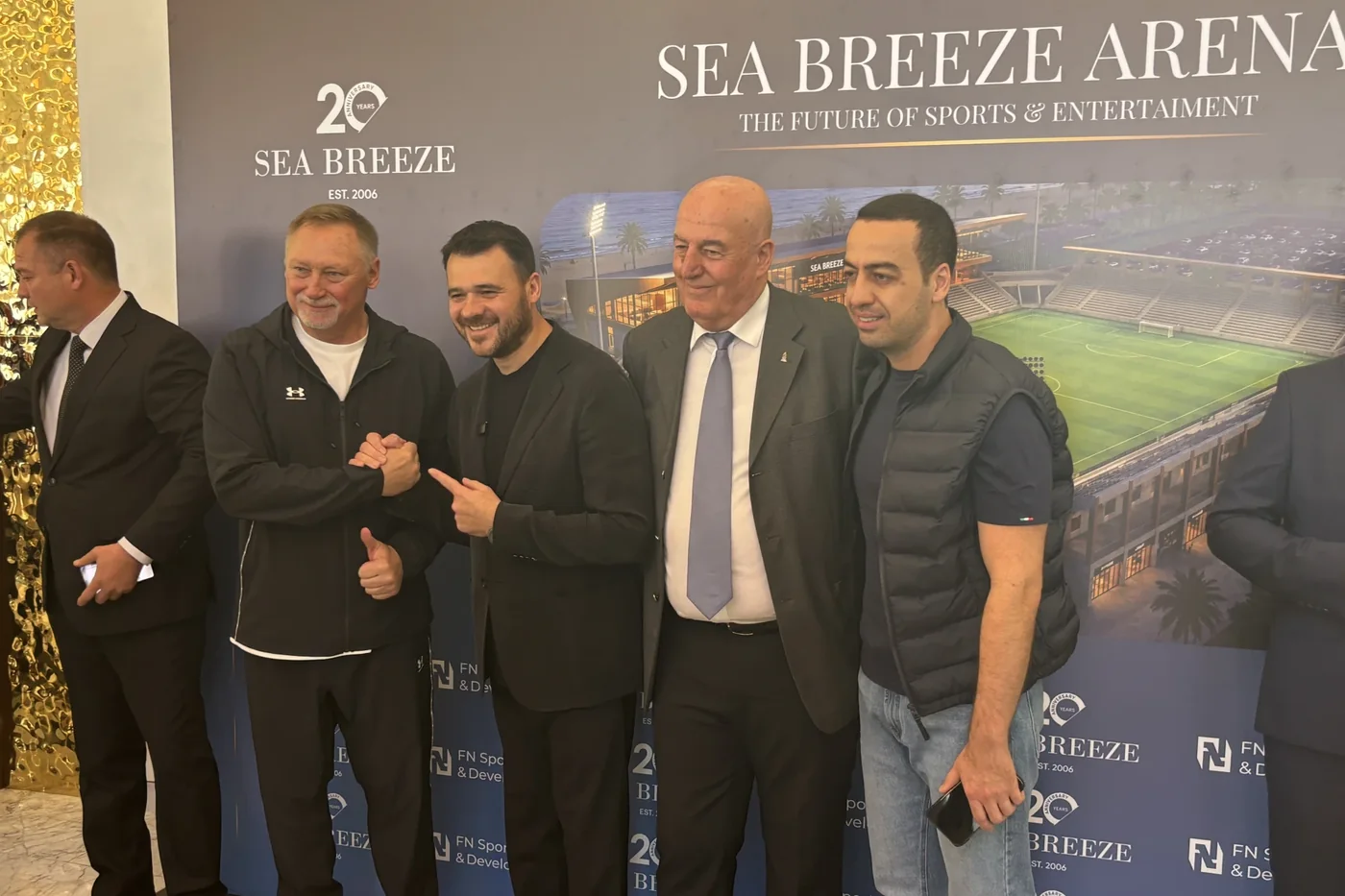 Гости презентации у баннера «Sea Breeze Arena — The future of sports & entertainment»